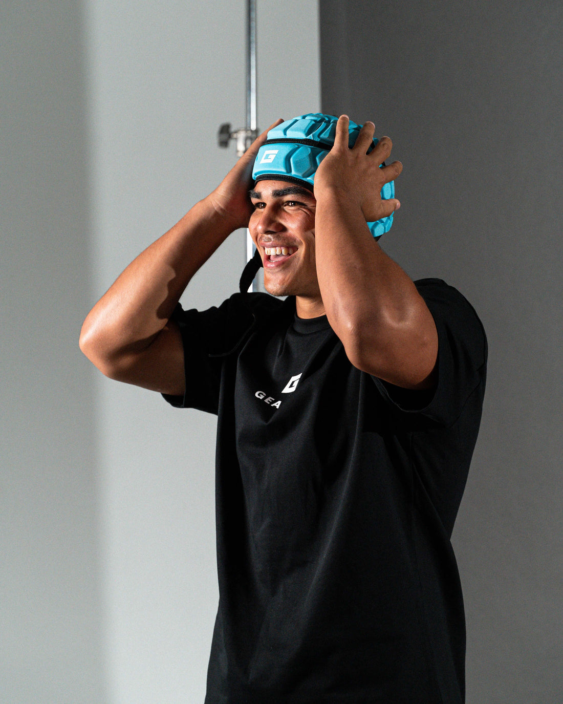GearFit Aqua rugby headgear in bright blue, lifestyle photo